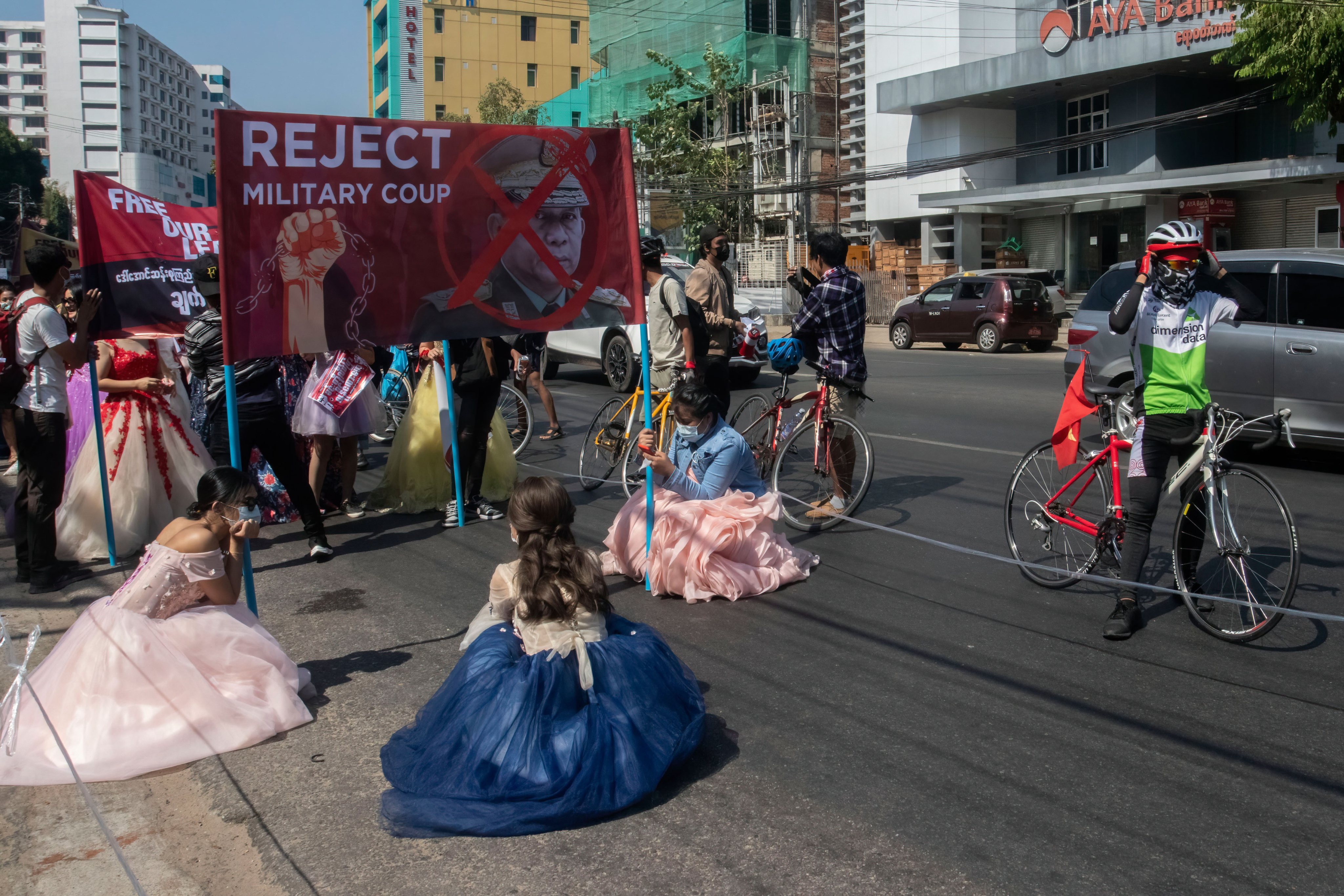 Protesters wearing wedding dresses march on the street