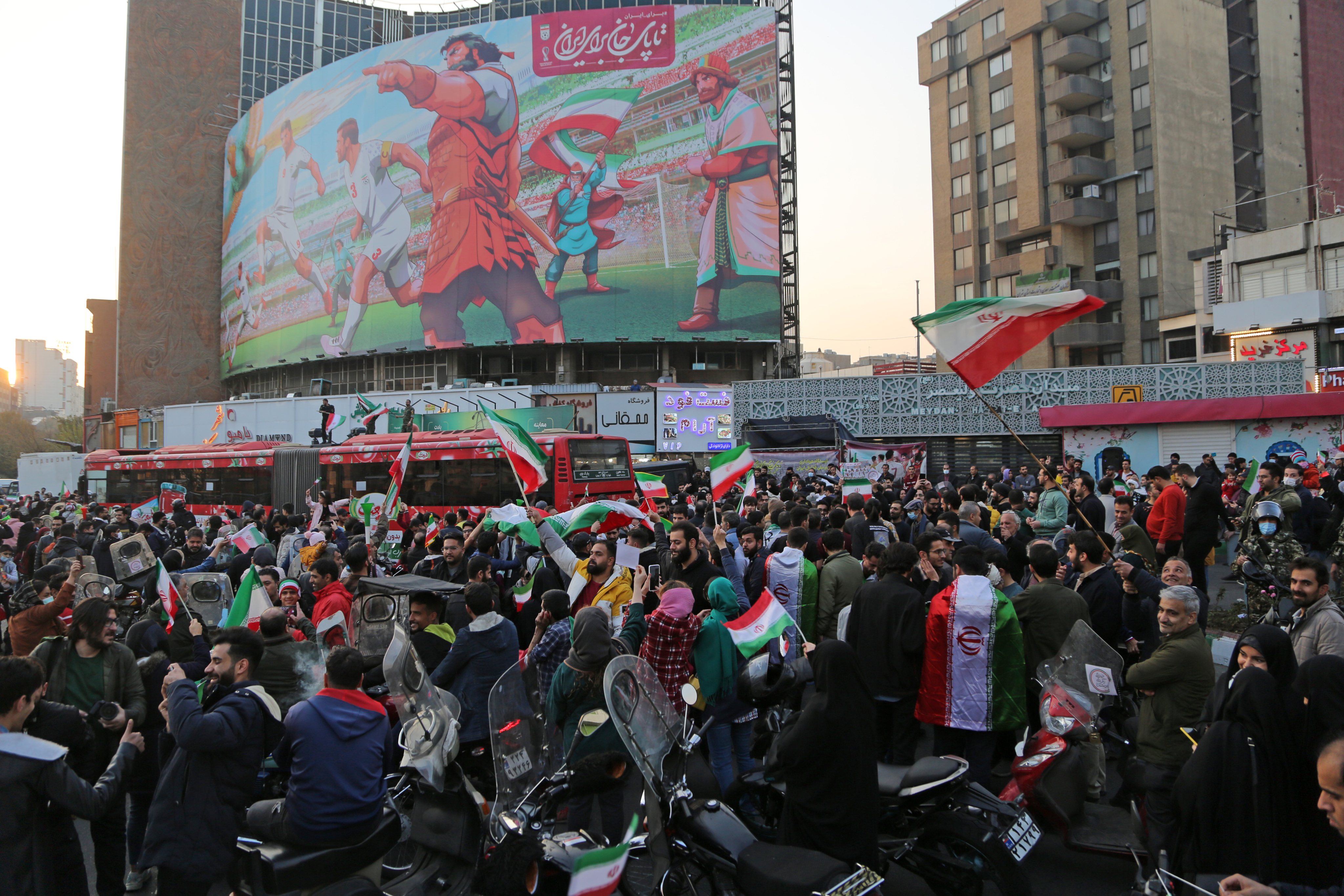 People celebrate after Iran's victory against Wales