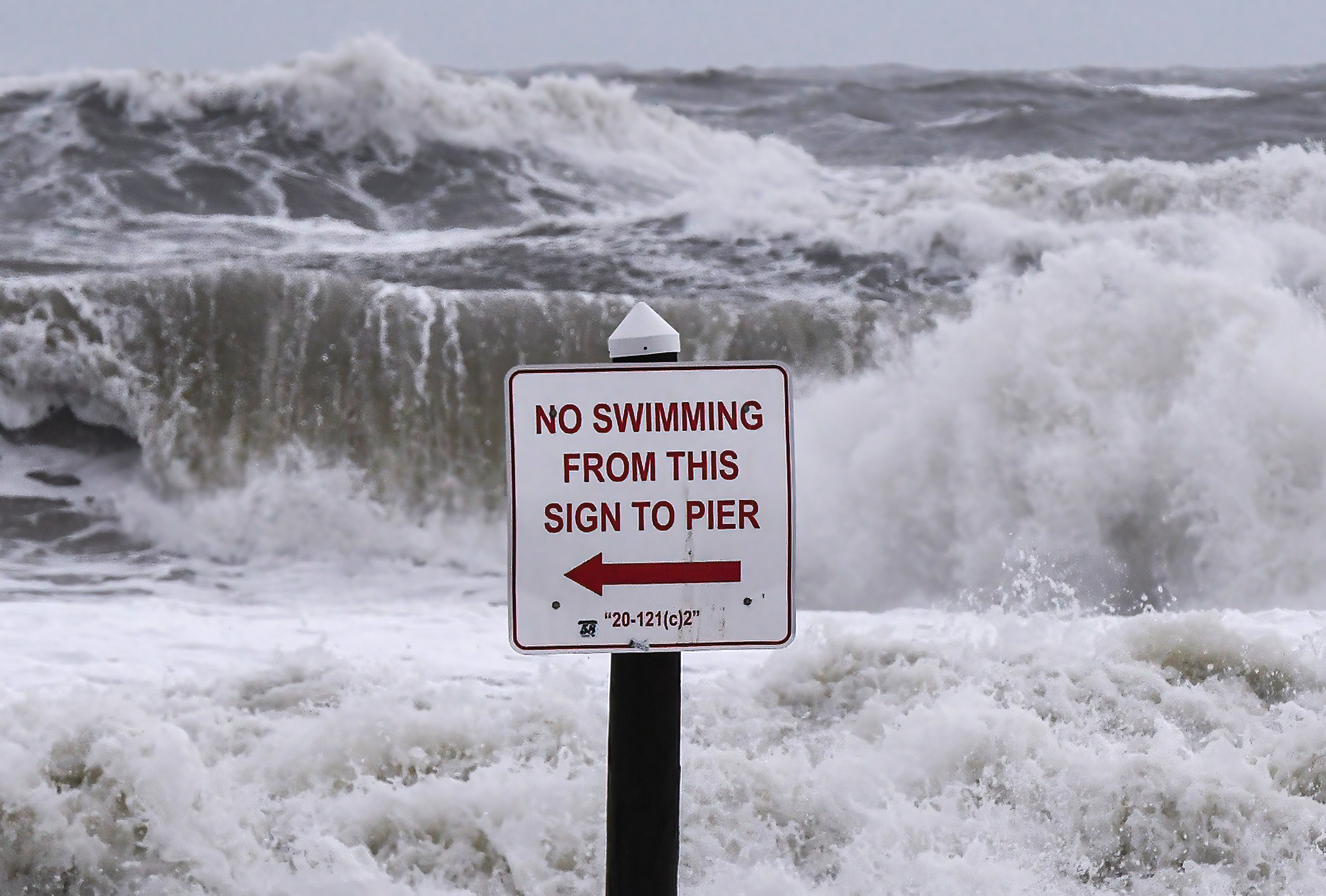 Rough surf is seen near a No Swimming sign in Daytona Beach