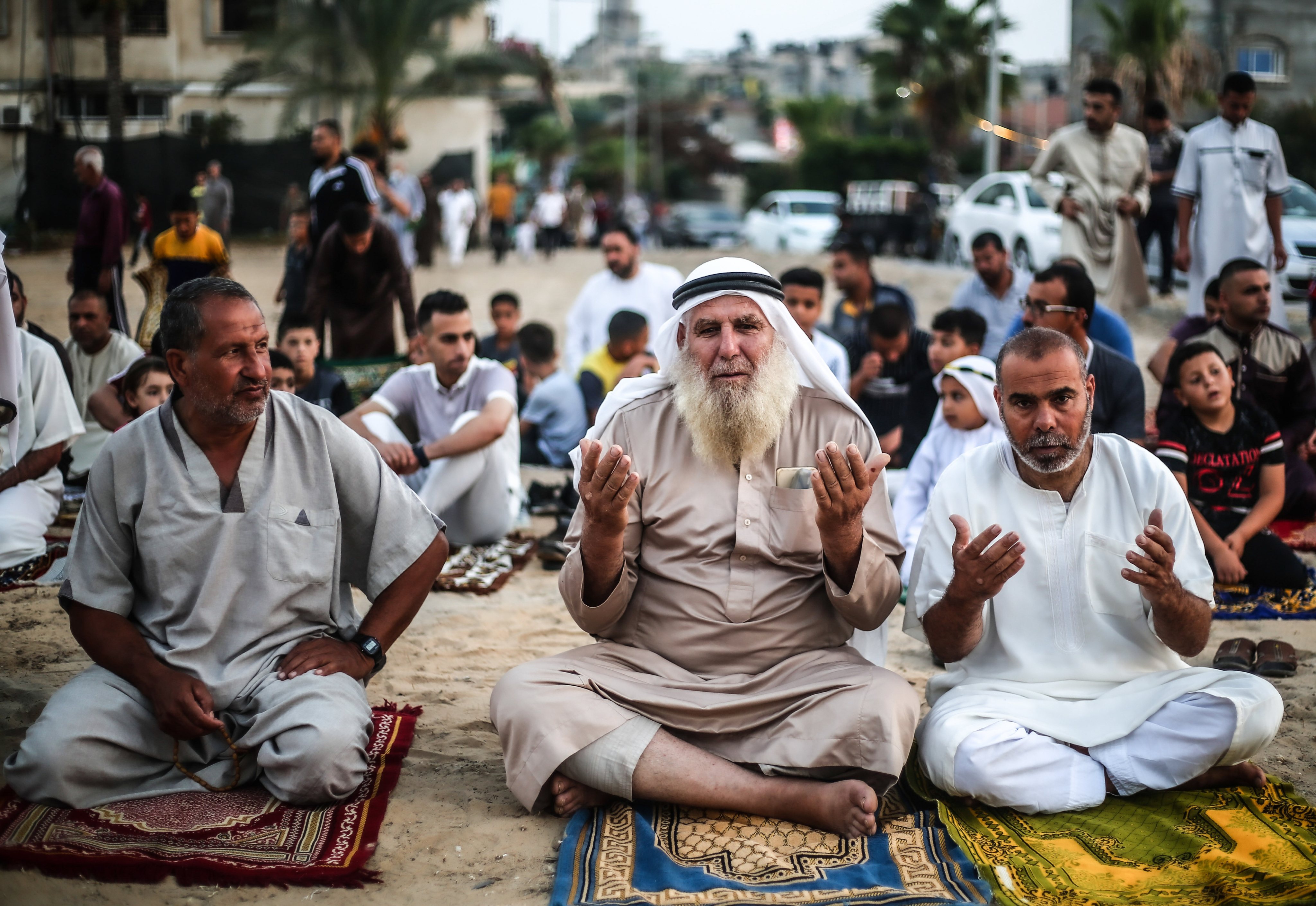 Palestinian Muslims perform Eid al-Adha prayers in a &quot;yard&quot;
