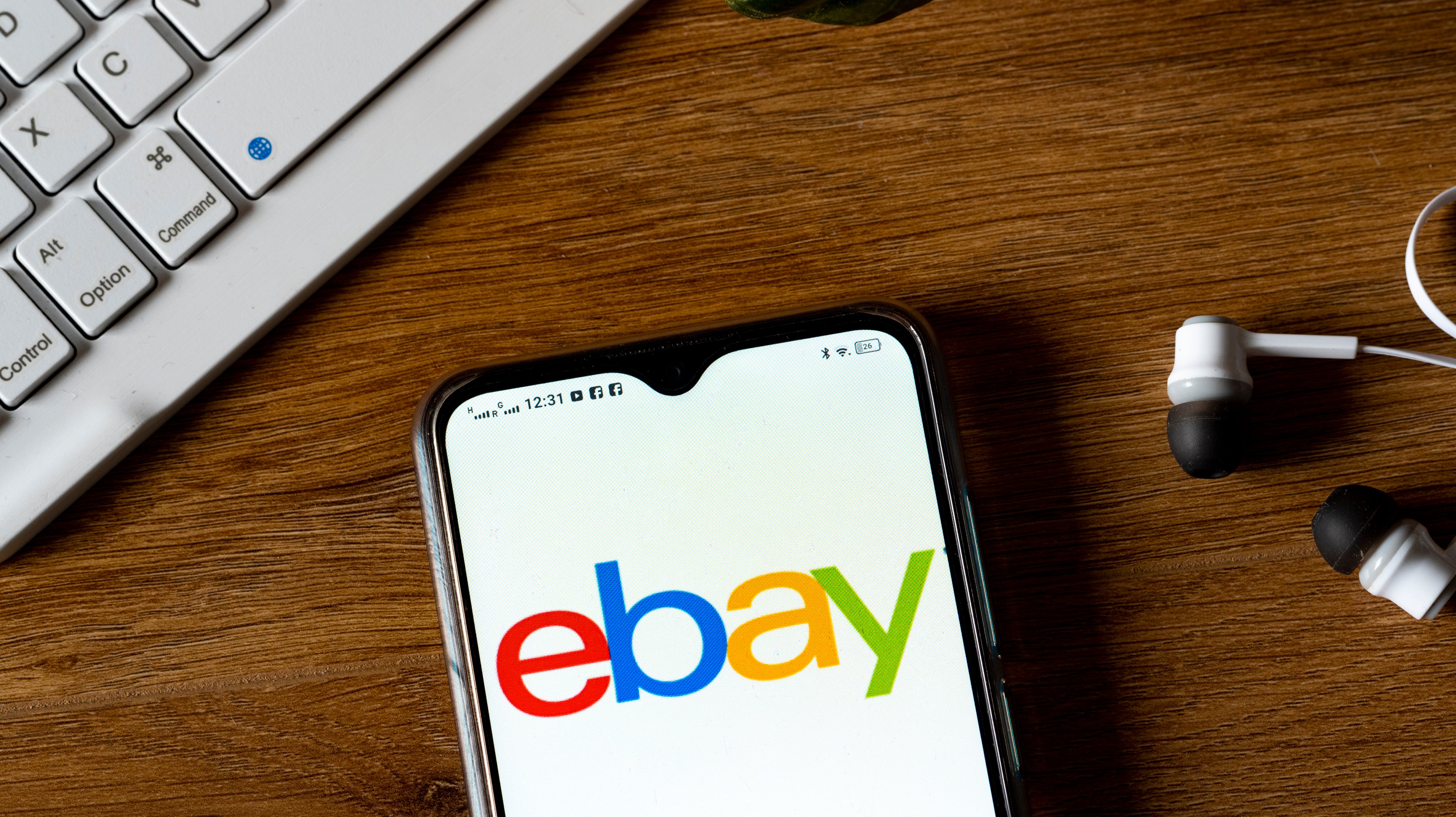 In this photo illustration an eBay logo seen displayed on a
