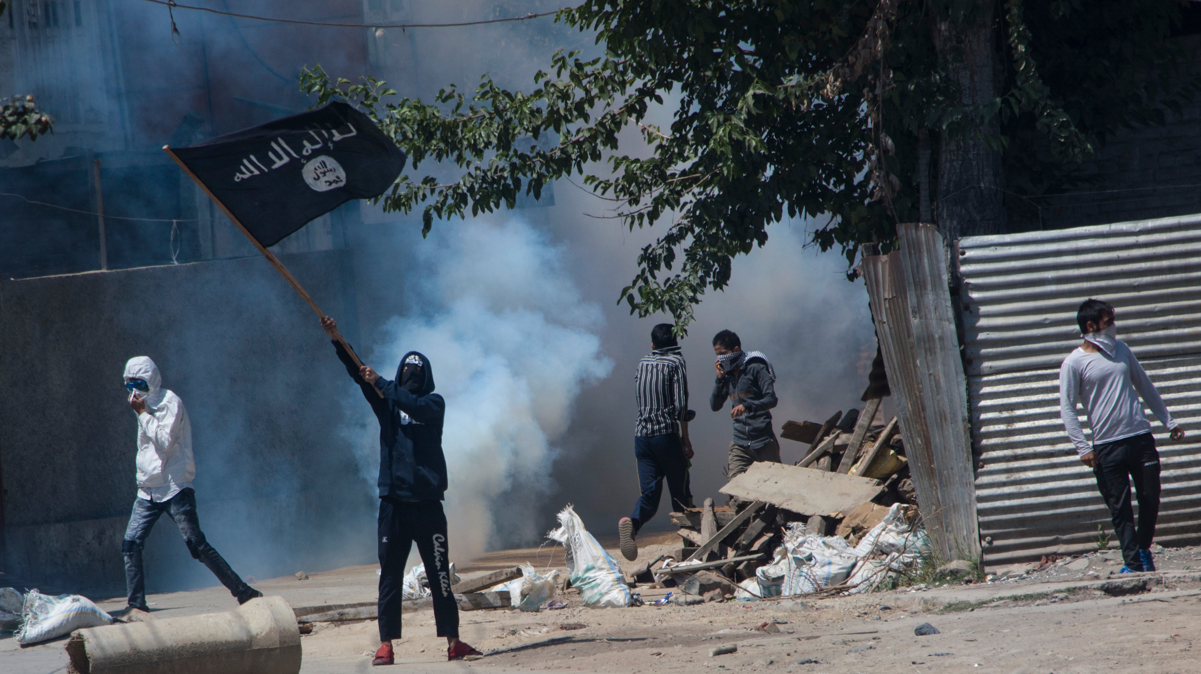 Kashmiri Muslim protestor waves ISIS flag during a funeral