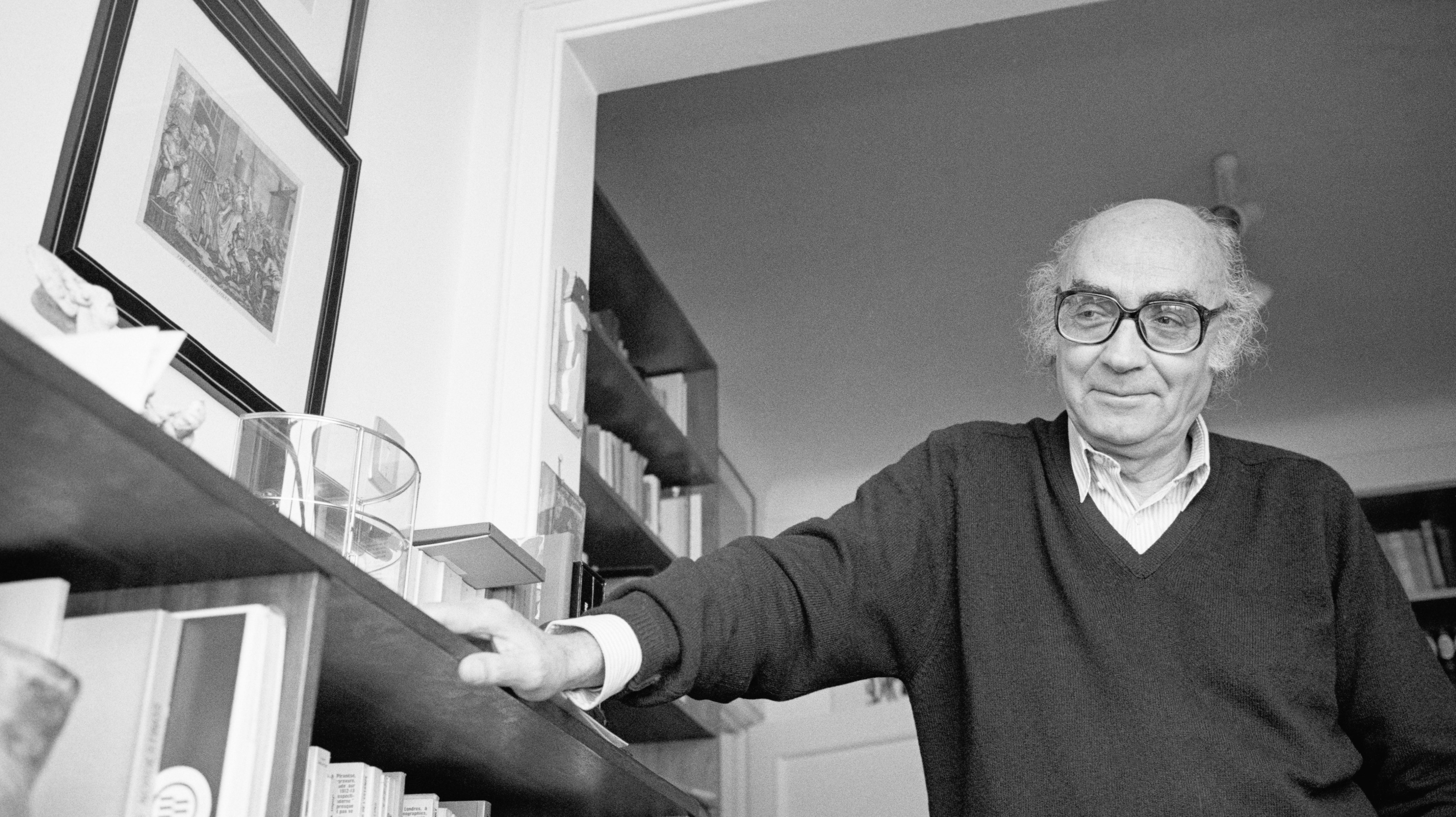 Writer Jose Saramago Leaning on Bookshelf