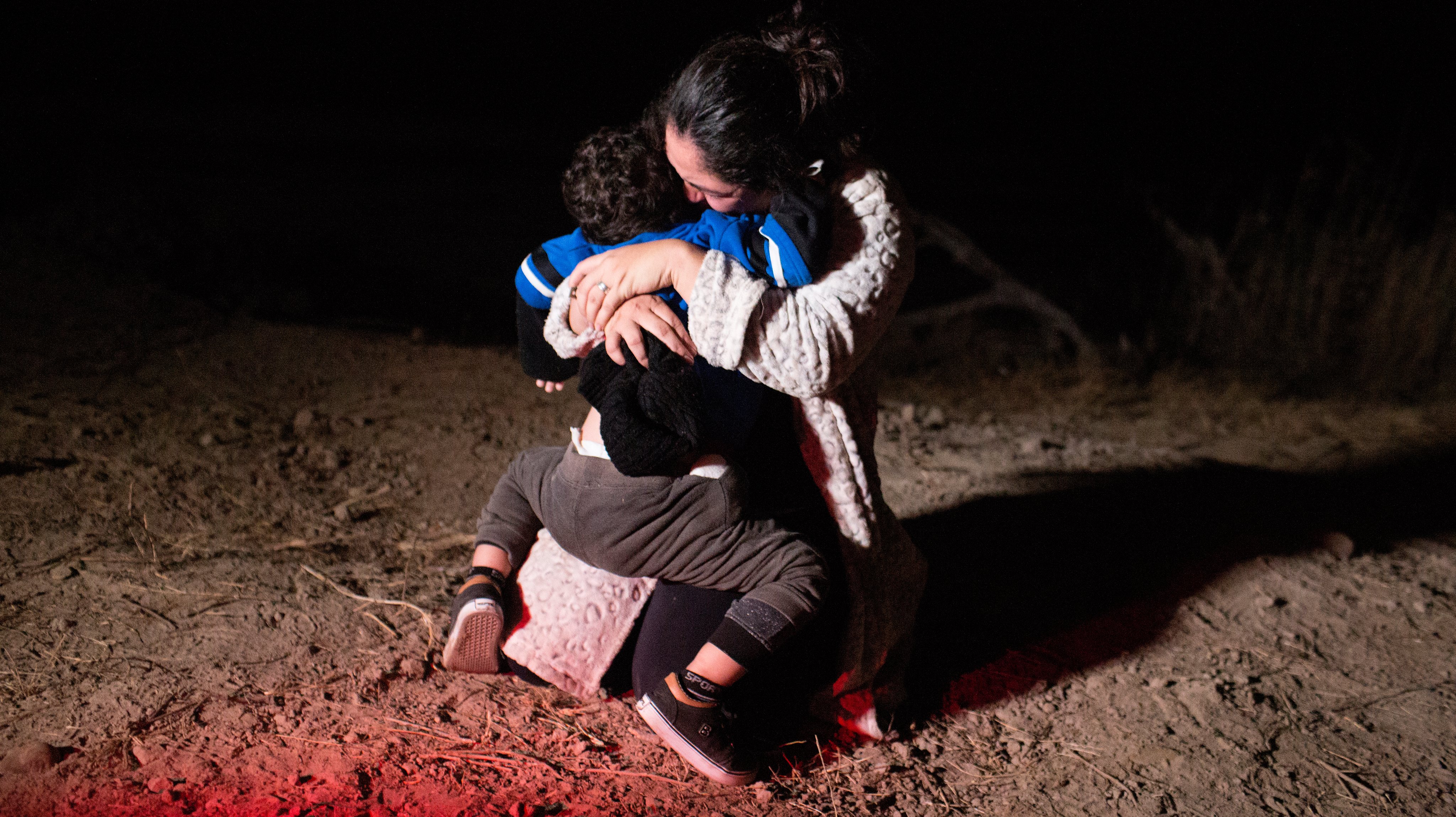 Refugee families cross into the United States along the Mexican Border