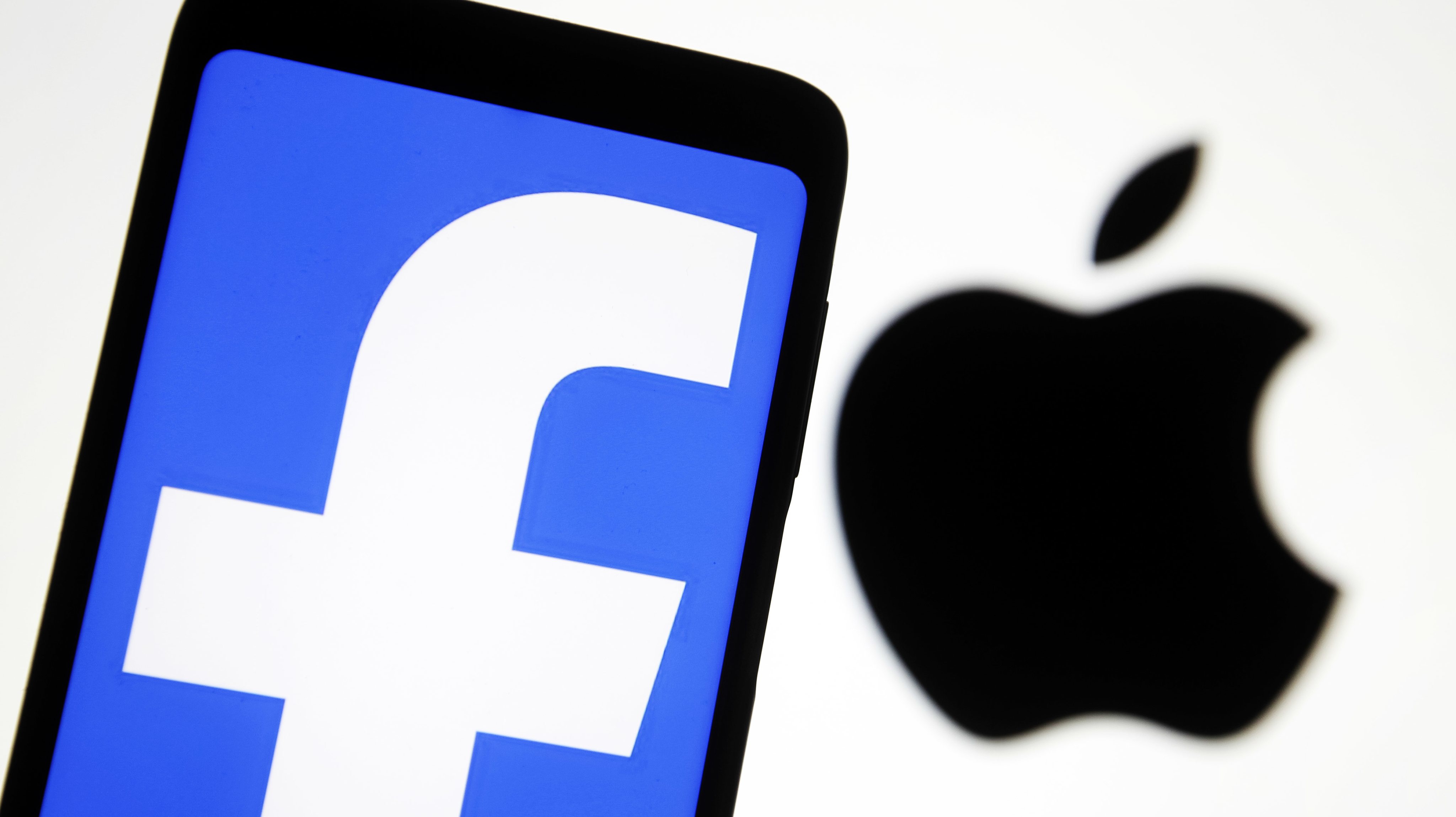 In this photo illustration the Apple and Facebook logos are