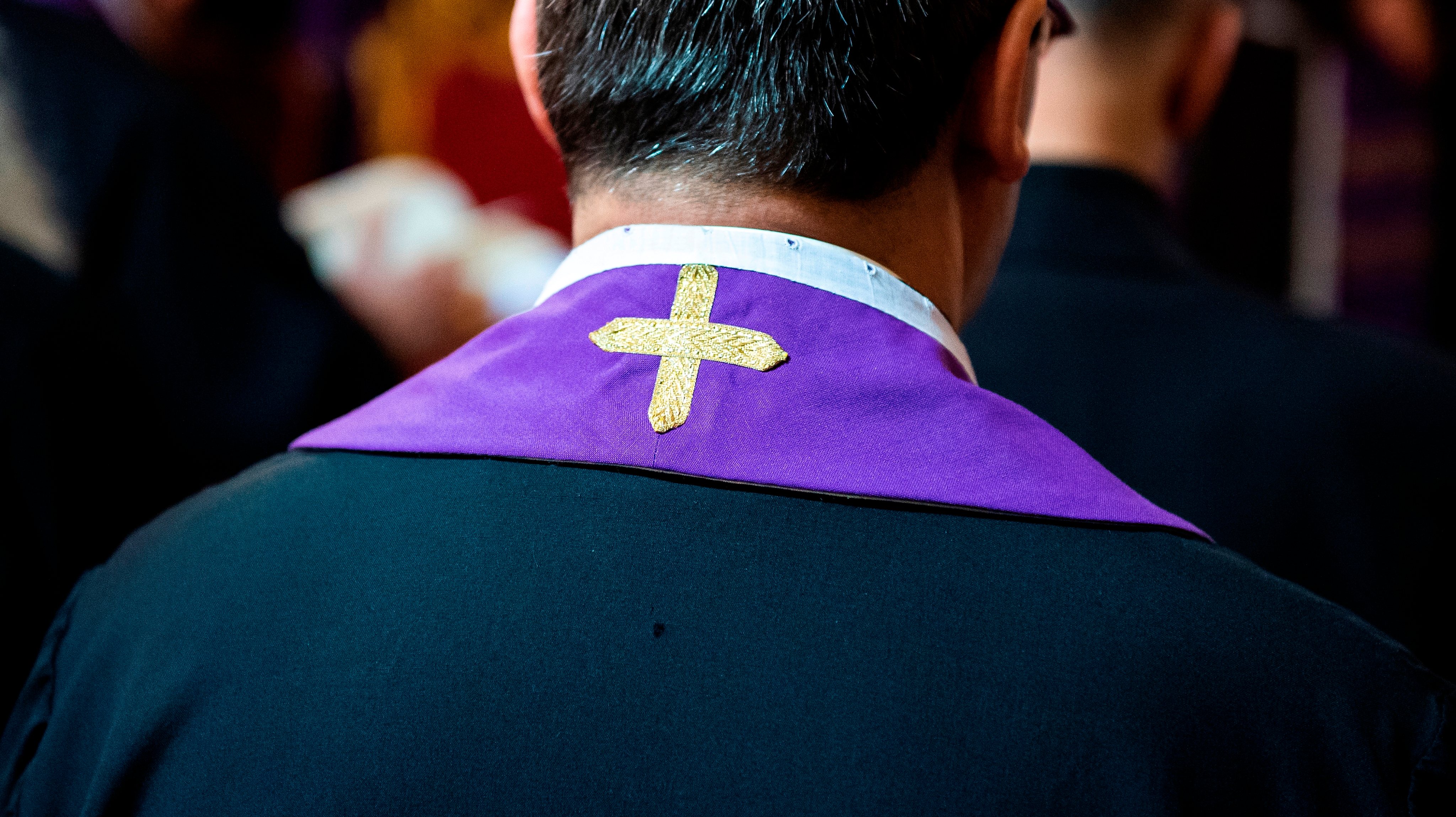 Priest wearing a purple stole in Rome, Italy.