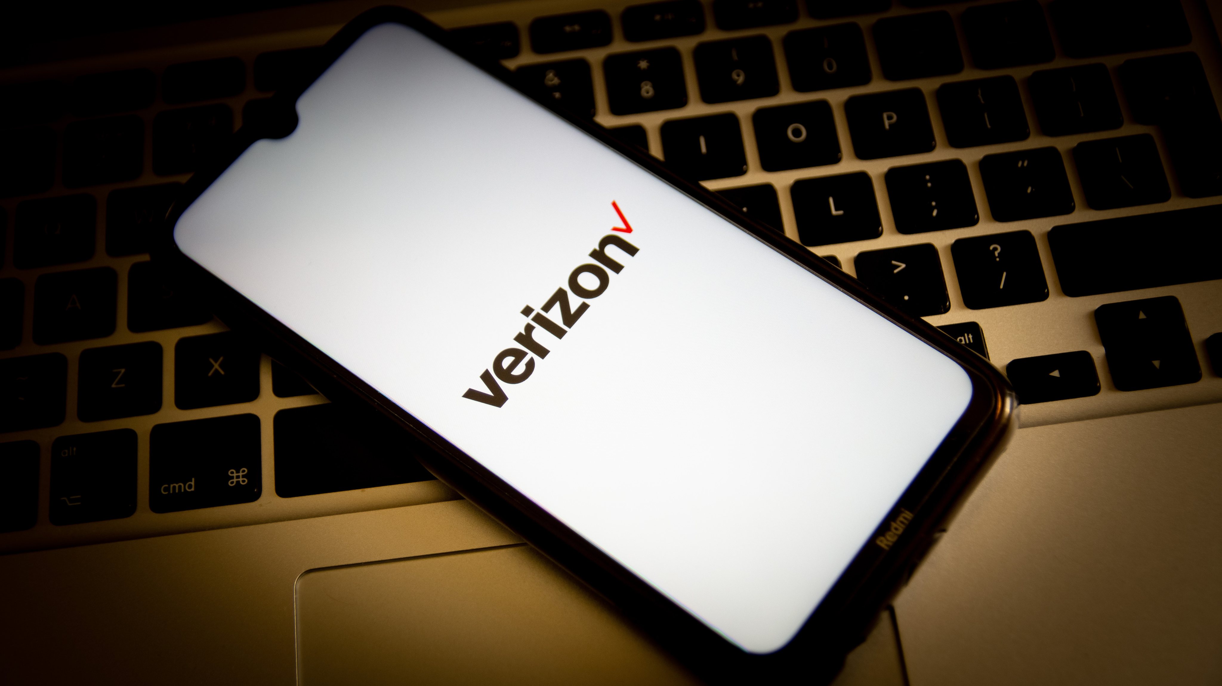 In this photo illustration, a Verizon logo seen displayed on
