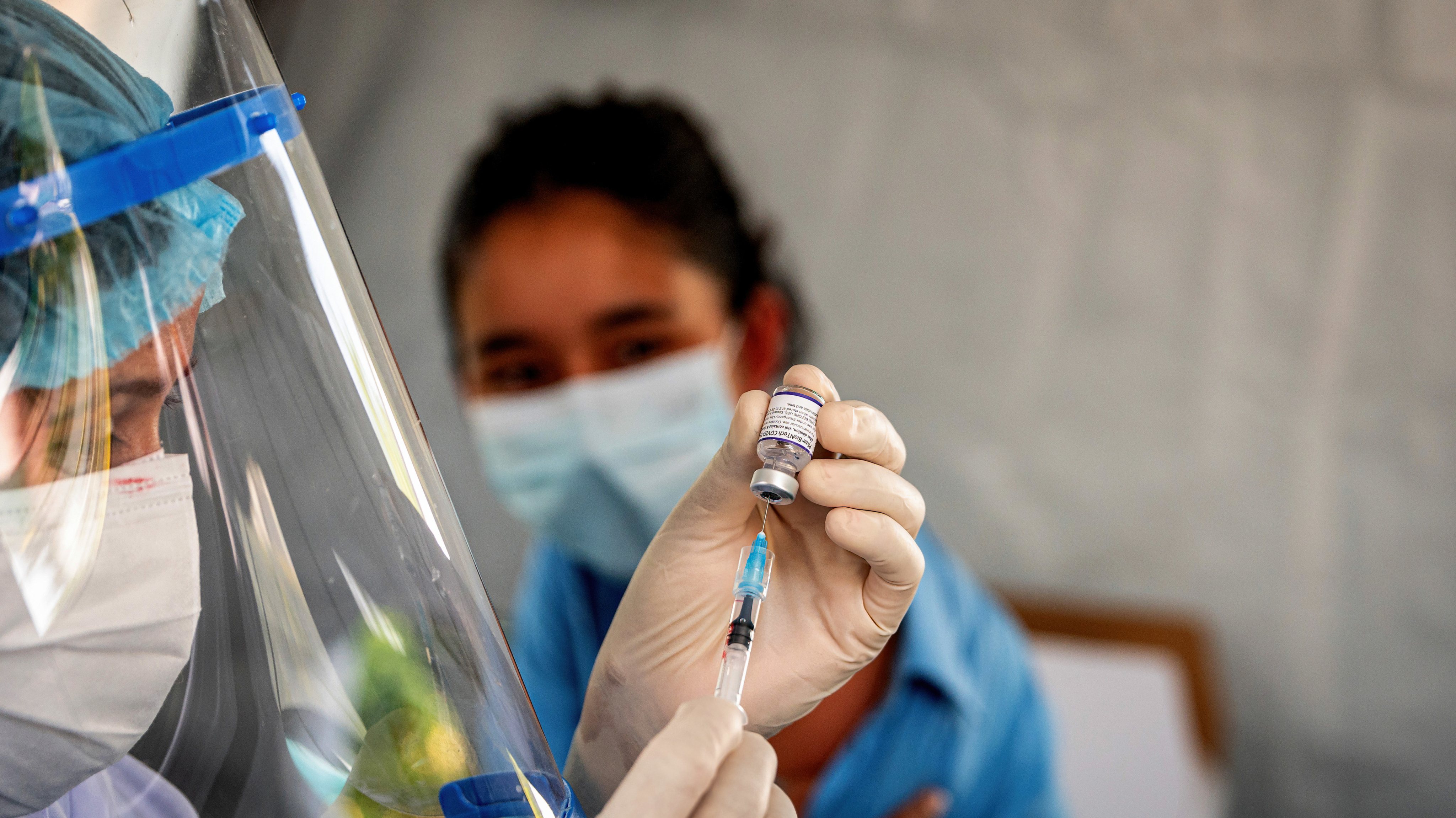 A health worker prepares the Pfizer-BioNTech vaccine at the