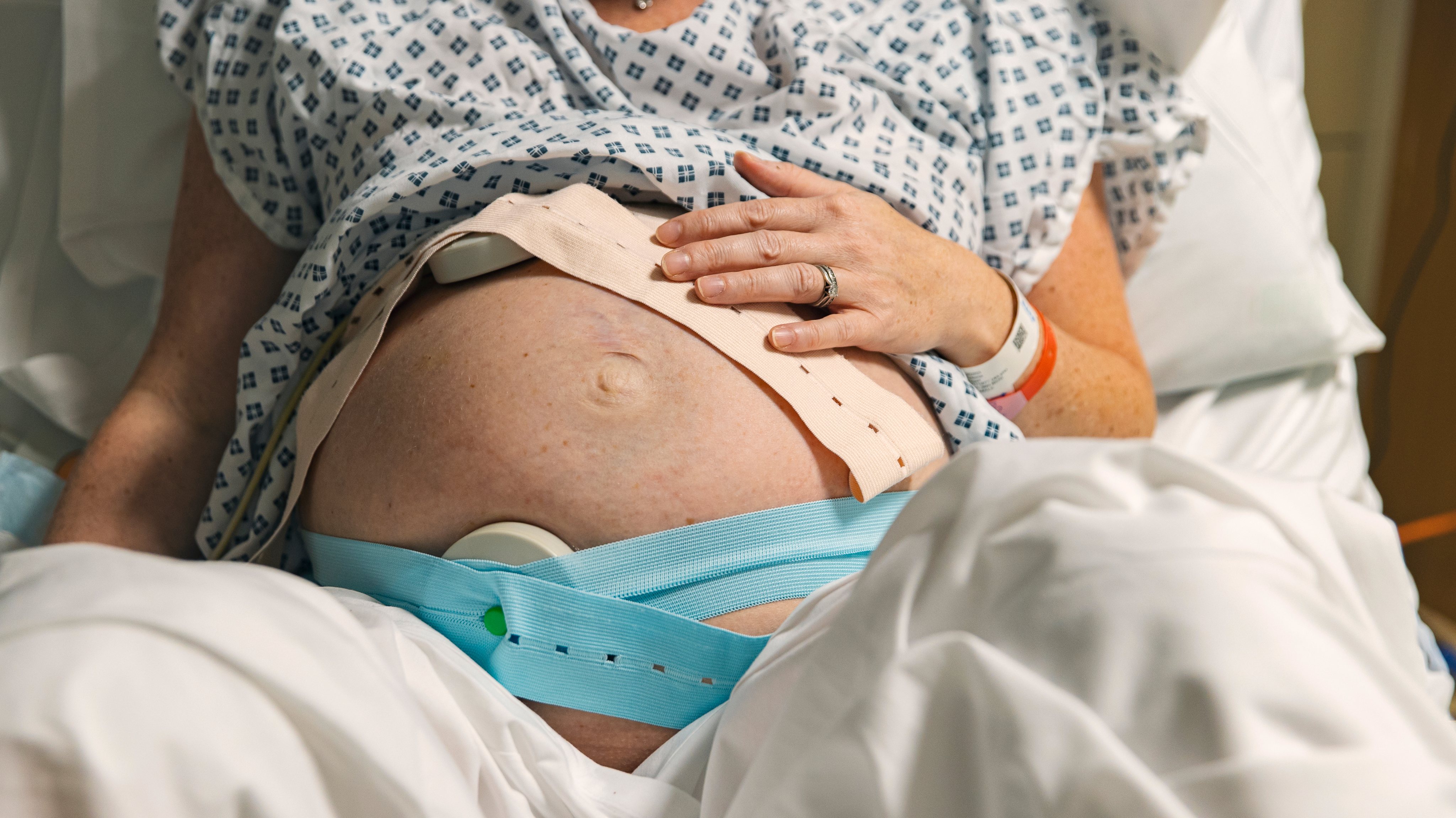 Unrecognisable pregnant woman in delivery room getting ready to give birth