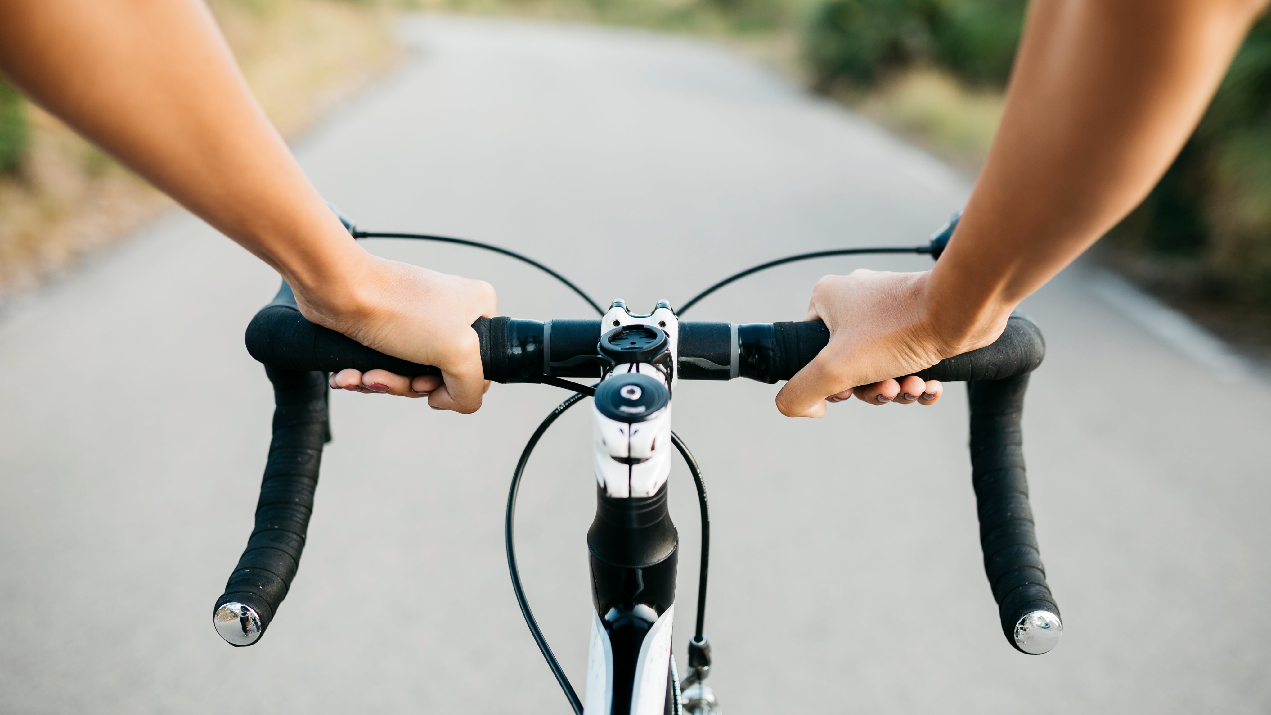 Woman&#039;s hands on a bicycle&#039;s handlebar