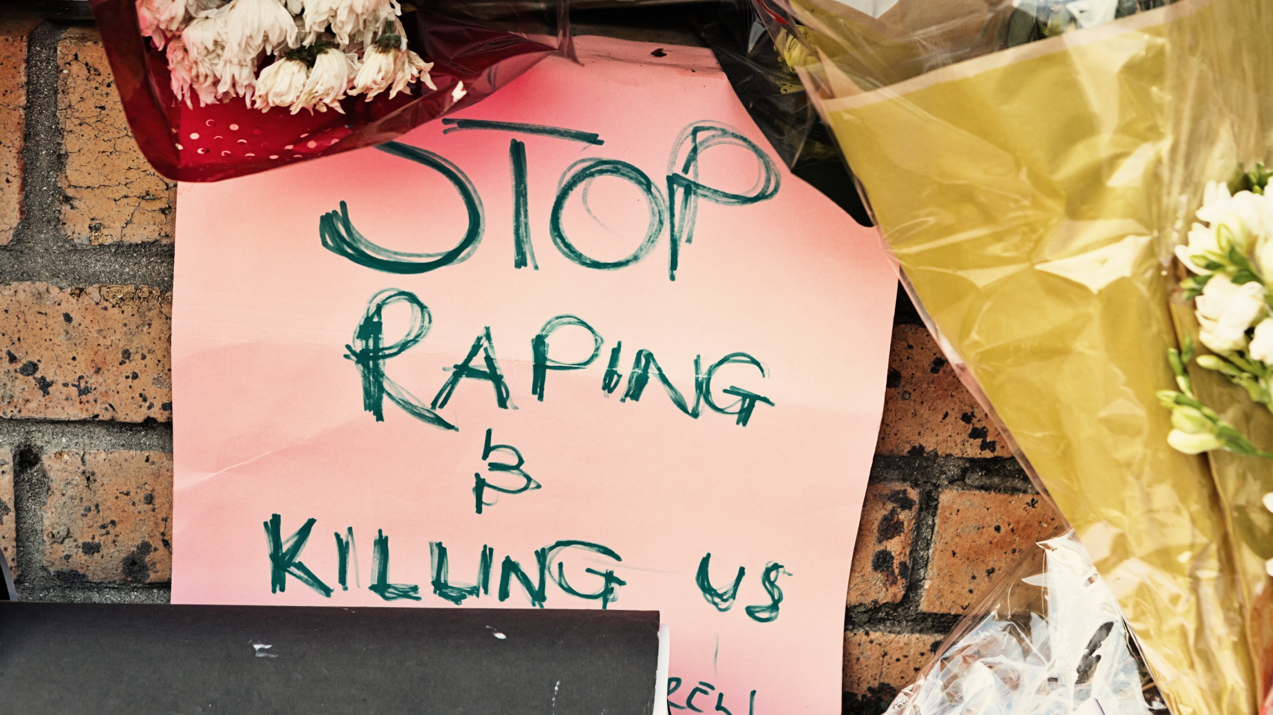 Sign left as a protest against gender violence at the scene of a rape and murder in Cape Town, South Africa