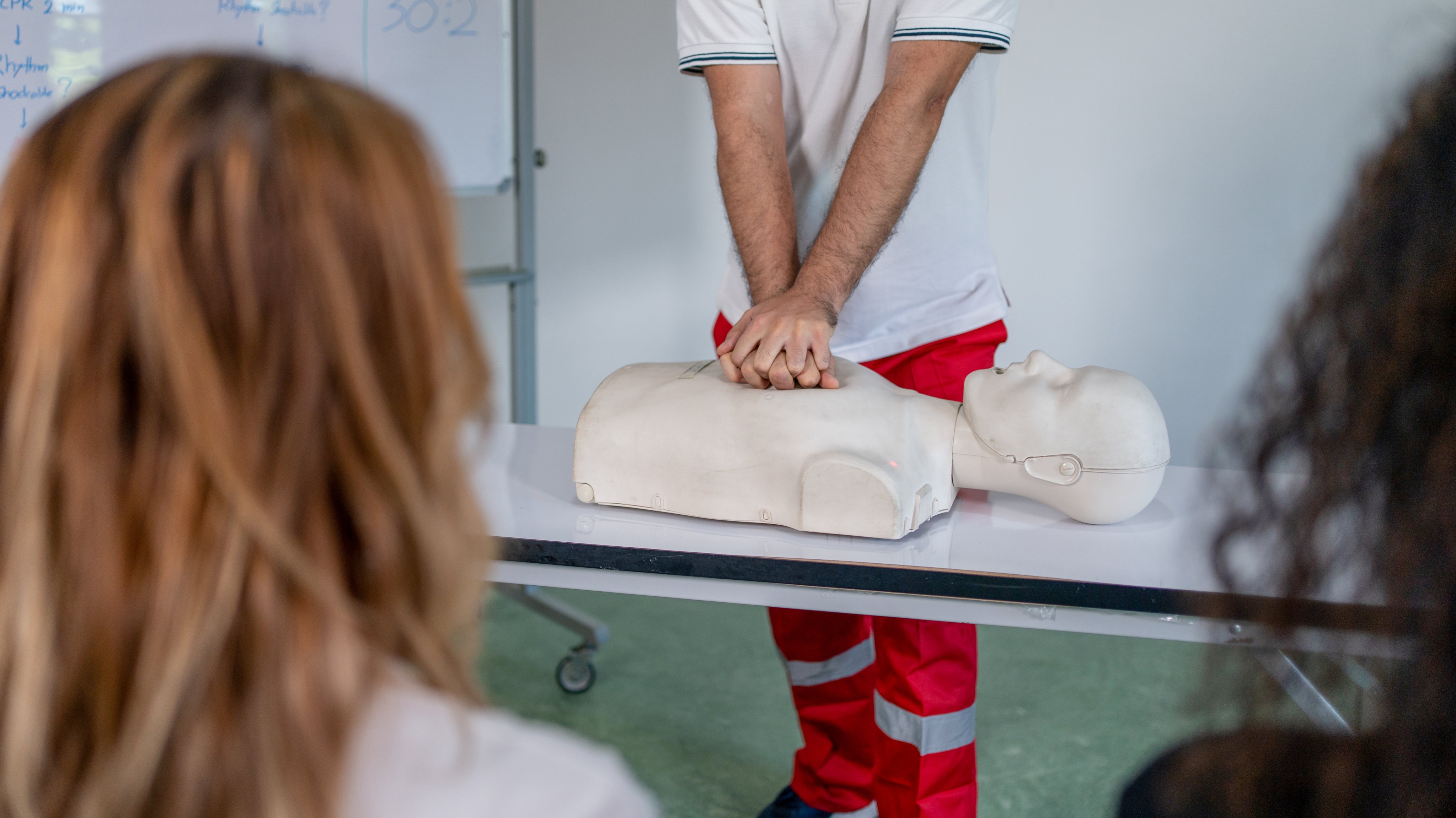 In the First-aid class, practice chest compressions on a CPR training dummy.