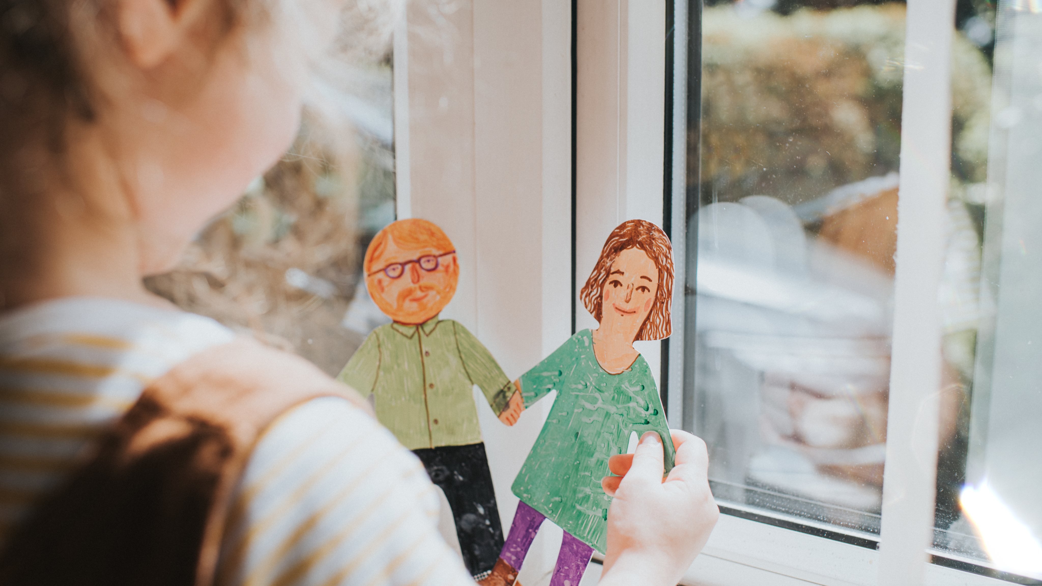 Little girl holding cut-out paper People