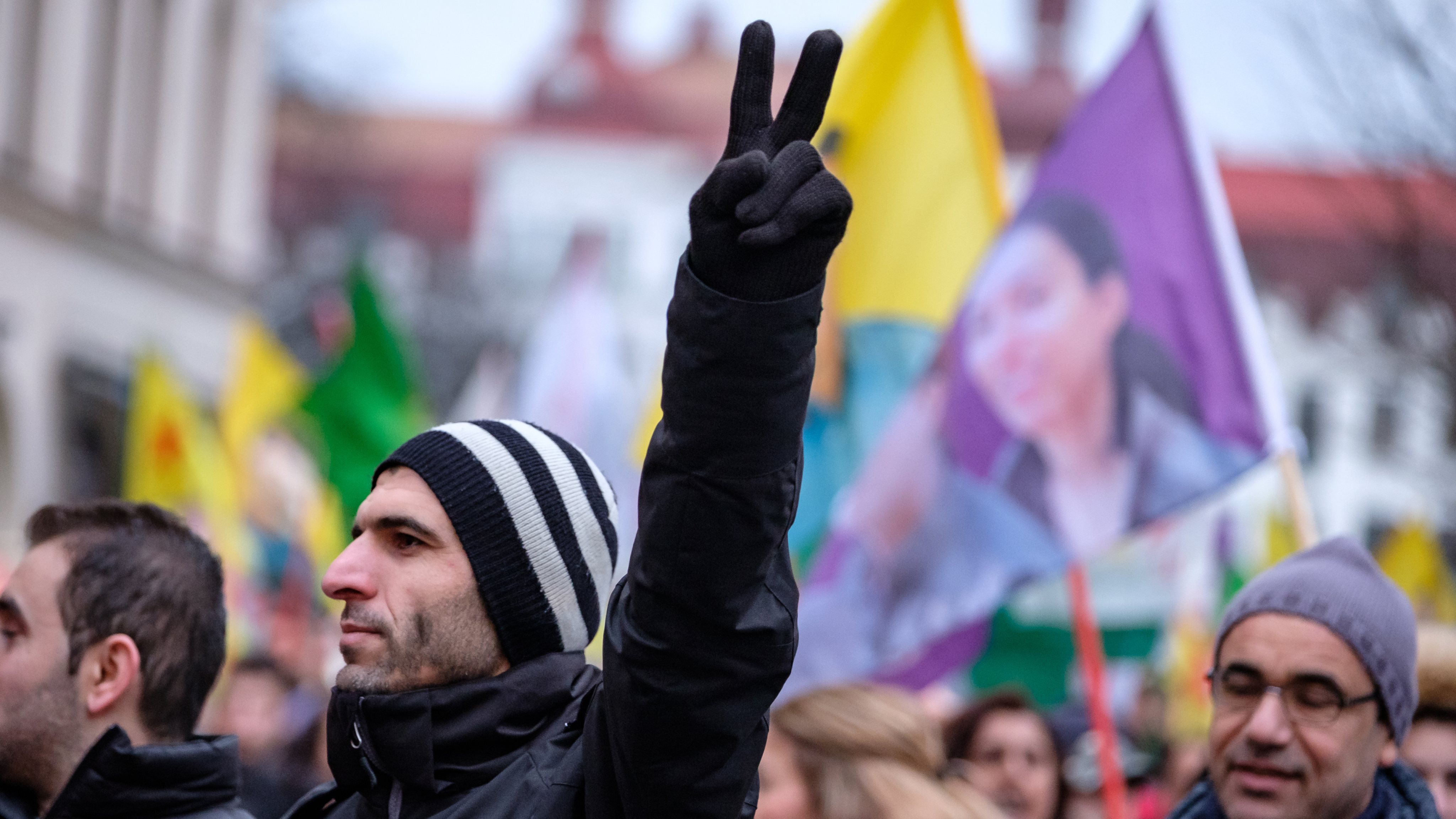 A demonstrator shows a victory sign during the demonstration