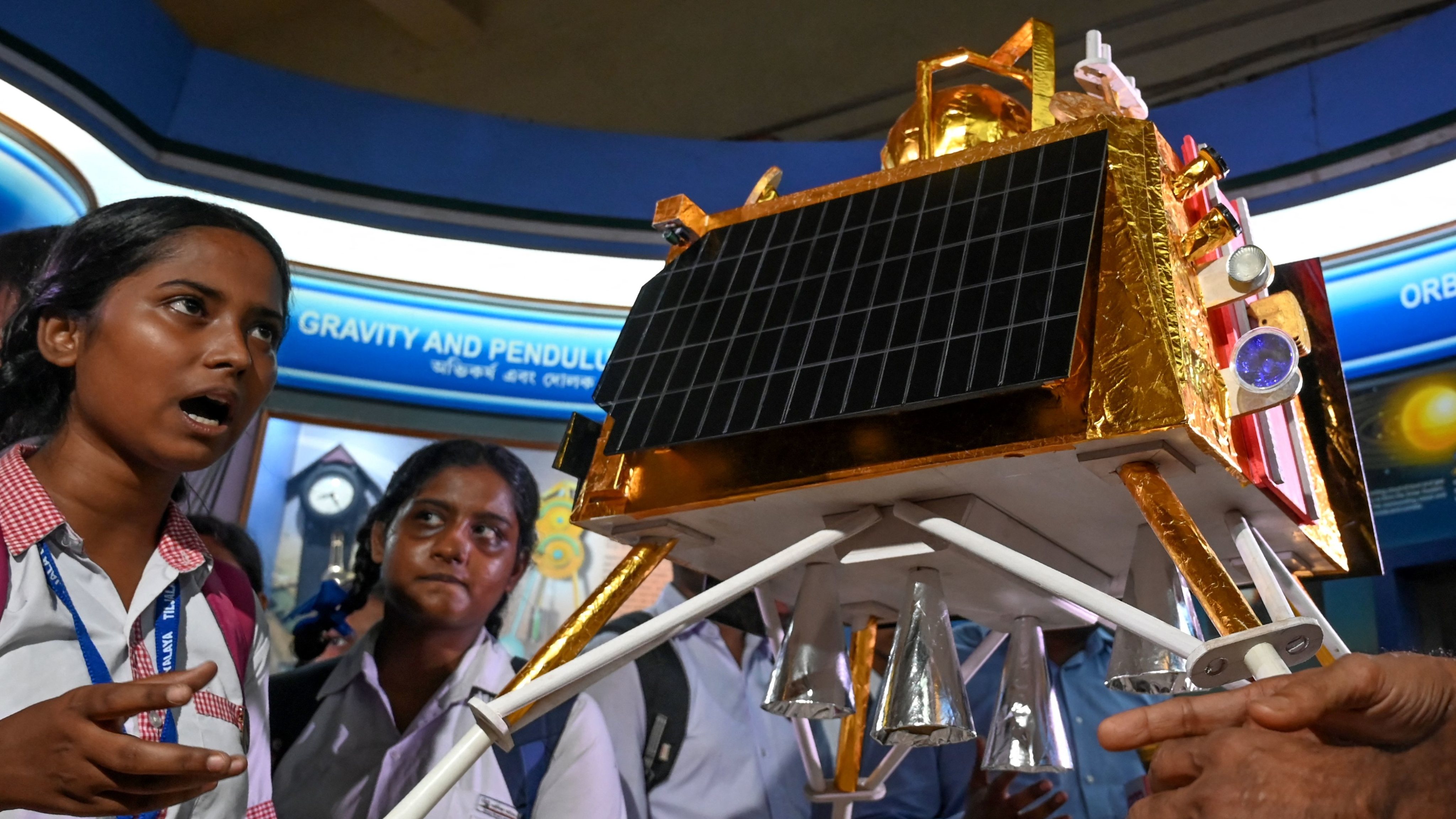 School students look at a model of Chandrayaan-3&#039;s Lander Module (LM) named as Vikram, at a technical museum in Kolkata on August 23, 2023. India&#039;s bid to become the first nation to land a spacecraft on the Moon&#039;s south pole neared its conclusion on August 23, the latest lunar push that has drawn in the world&#039;s top powers and new players.