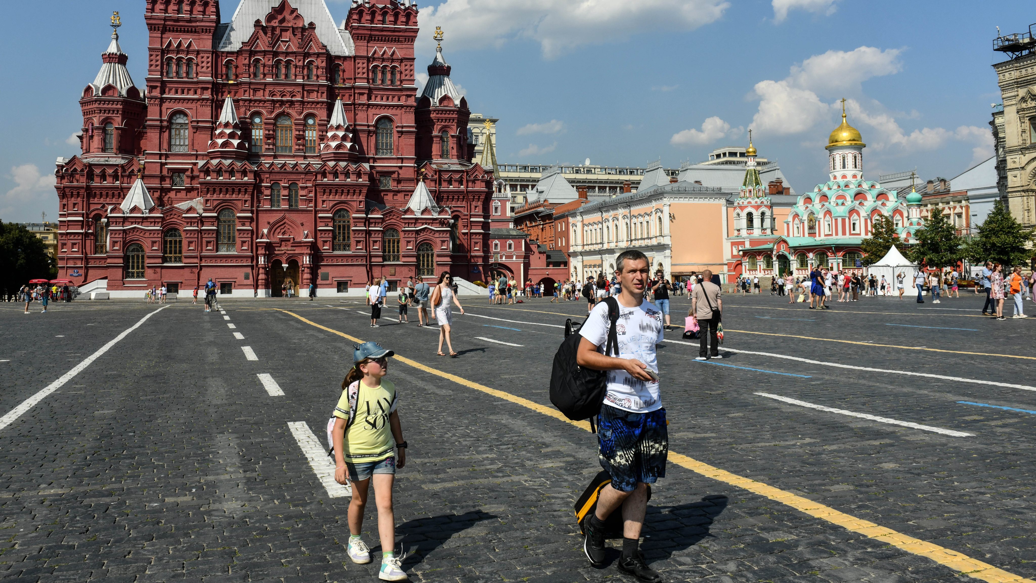 Father and daughter walk around the Red Square