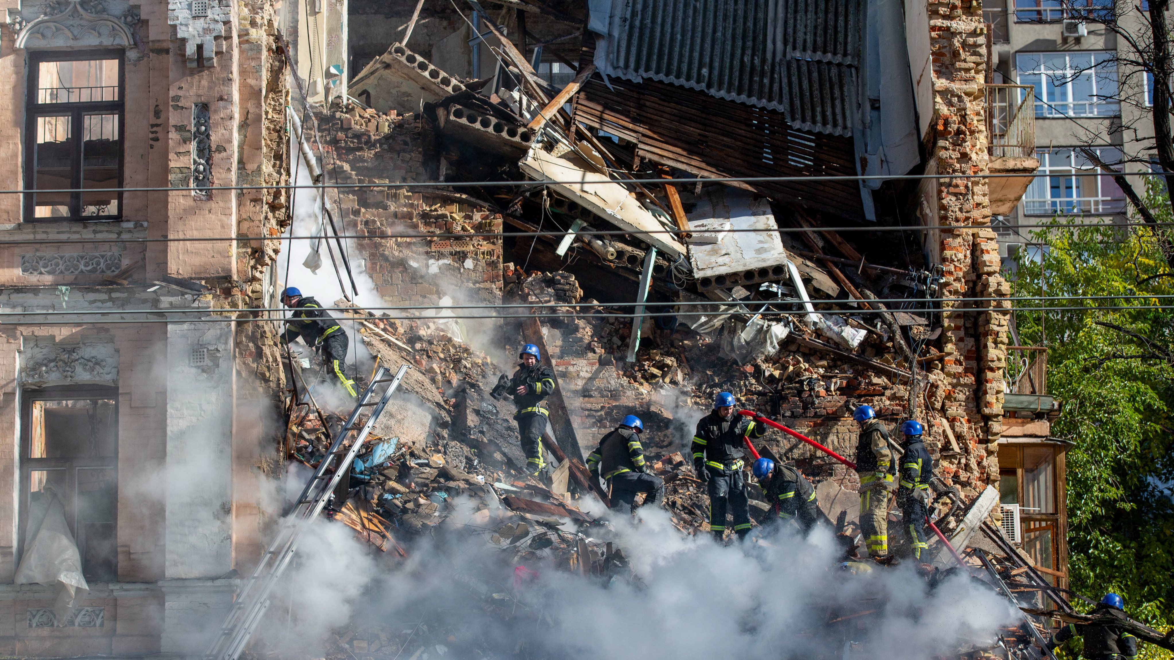 Ukrainian rescuers work at the site of a residential