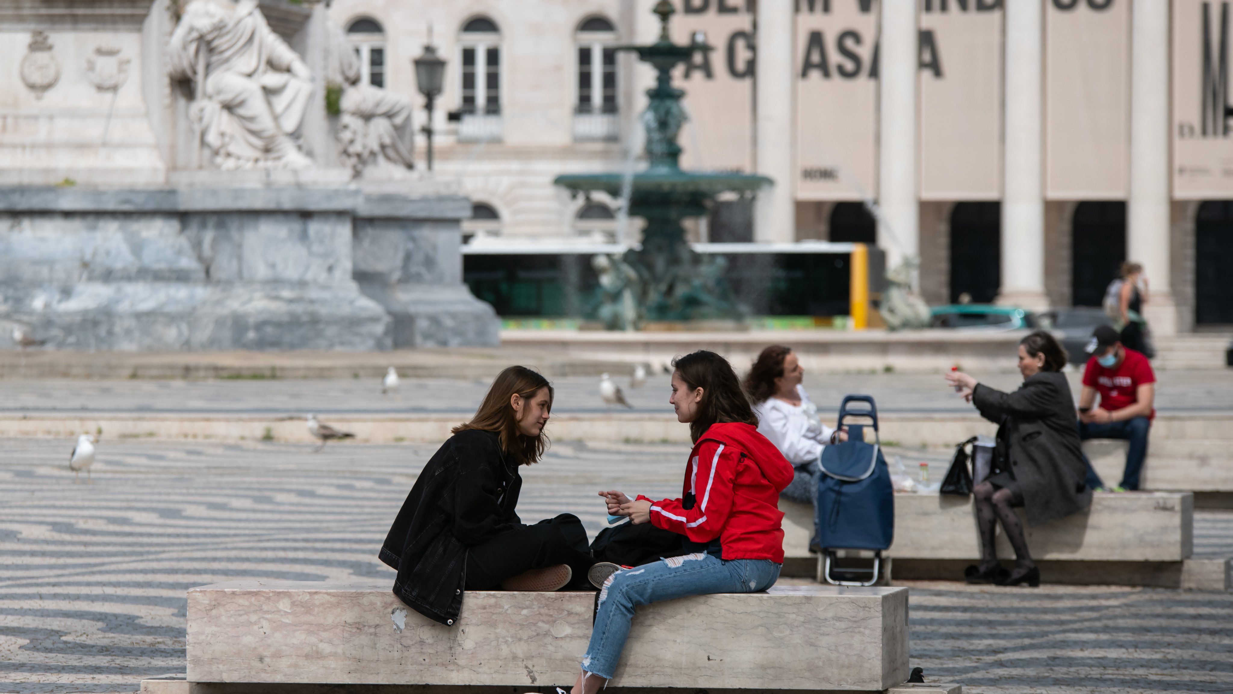 People seen relaxing at the Rossio square, in downtown