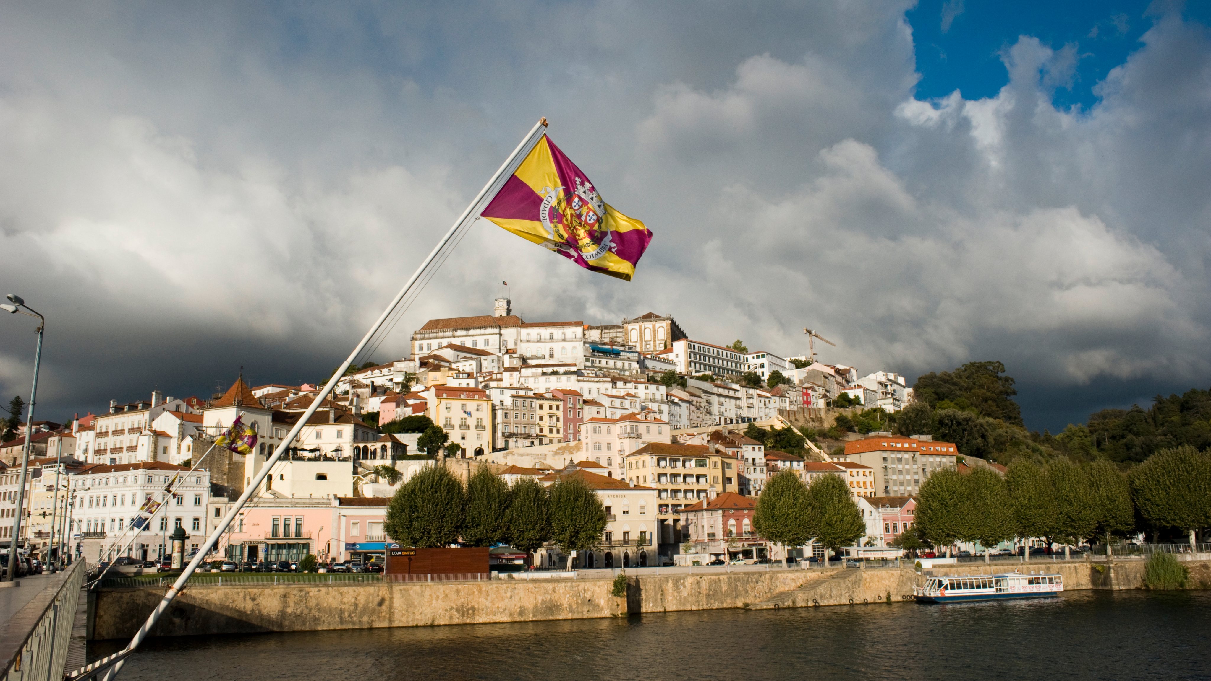 A flag flies in front of a view of the old city from the