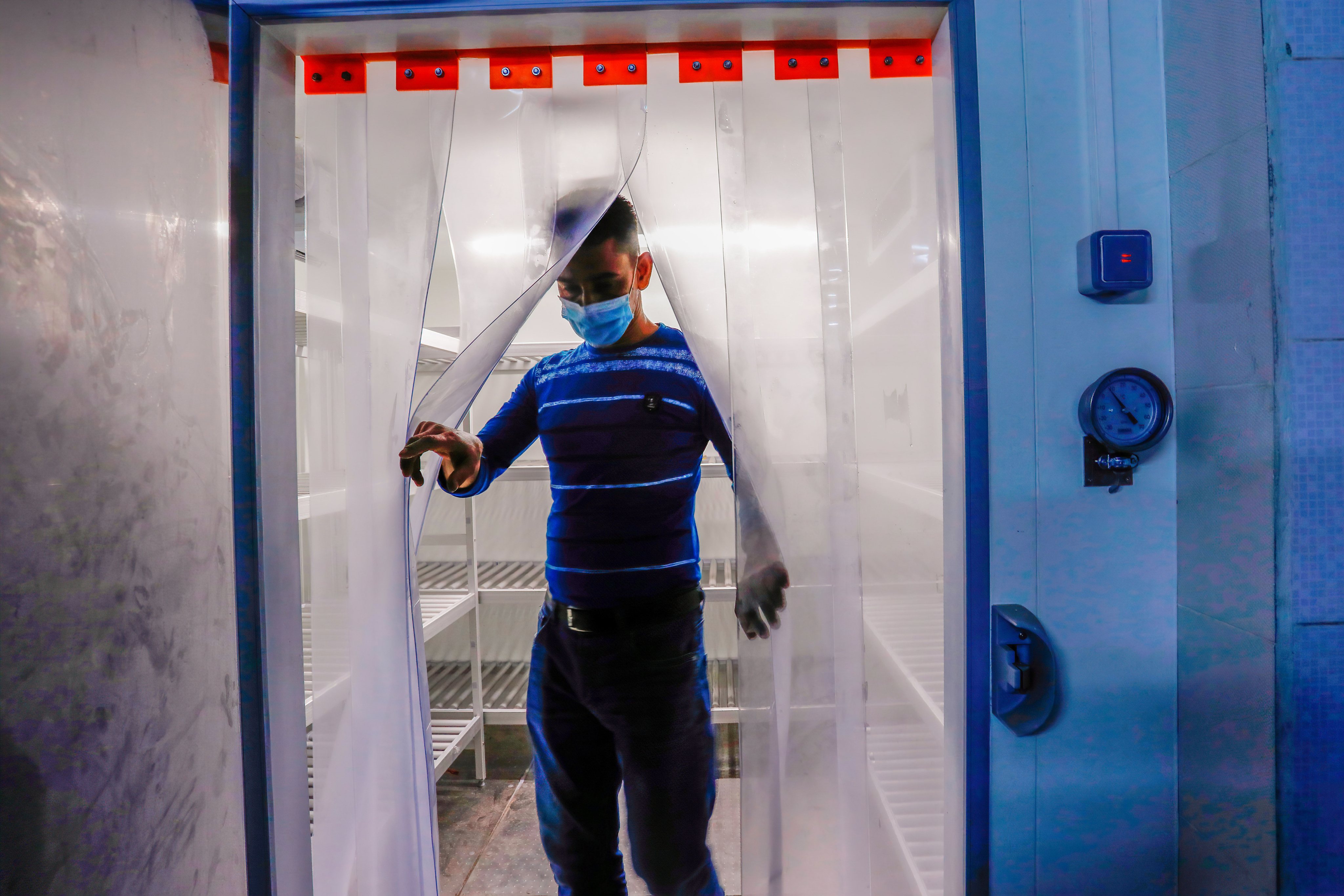 A technician seen exiting a cold storage room which is being