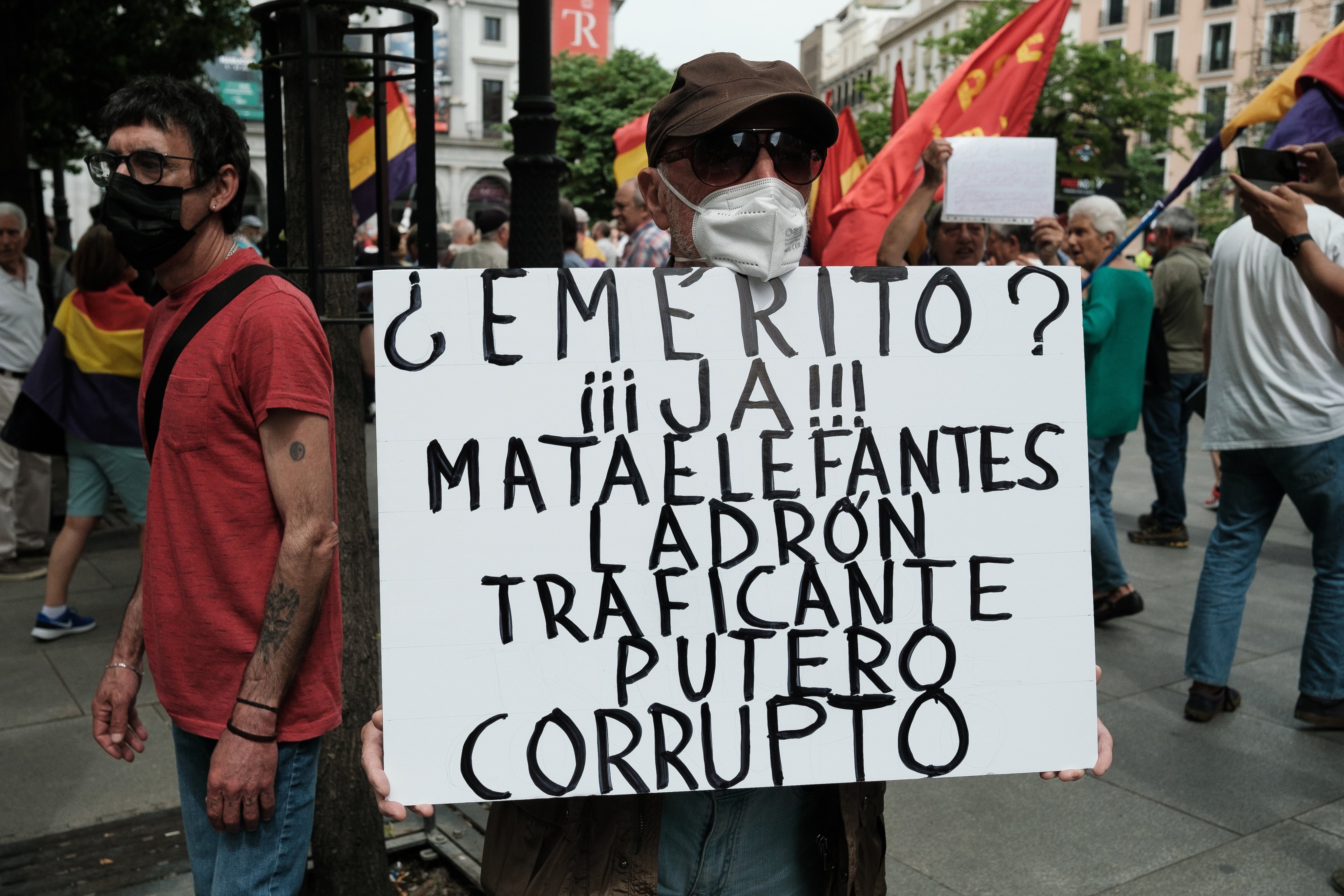 A protester holds a placard expressing his opinion during