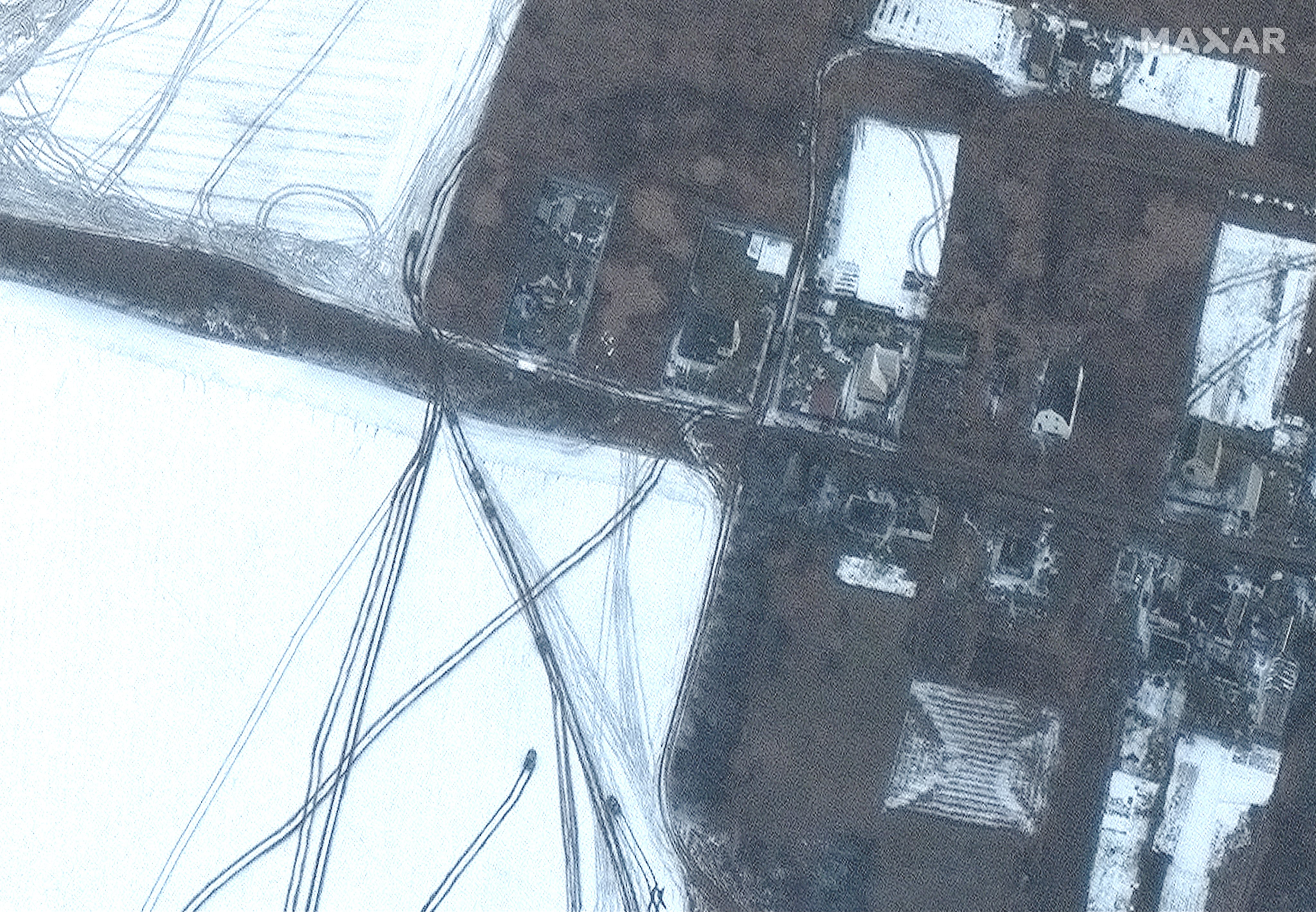 RUSSIANS INVADE UKRAINE -- MARCH 8, 2022:  02 Maxar satellite imagery, closer view of armored vehicles moving northeast of Antonov Airport outside of Hostomel, Ukraine.  8march2022_wv3.  Please use: Satellite image (c) 2022 Maxar Technologies.