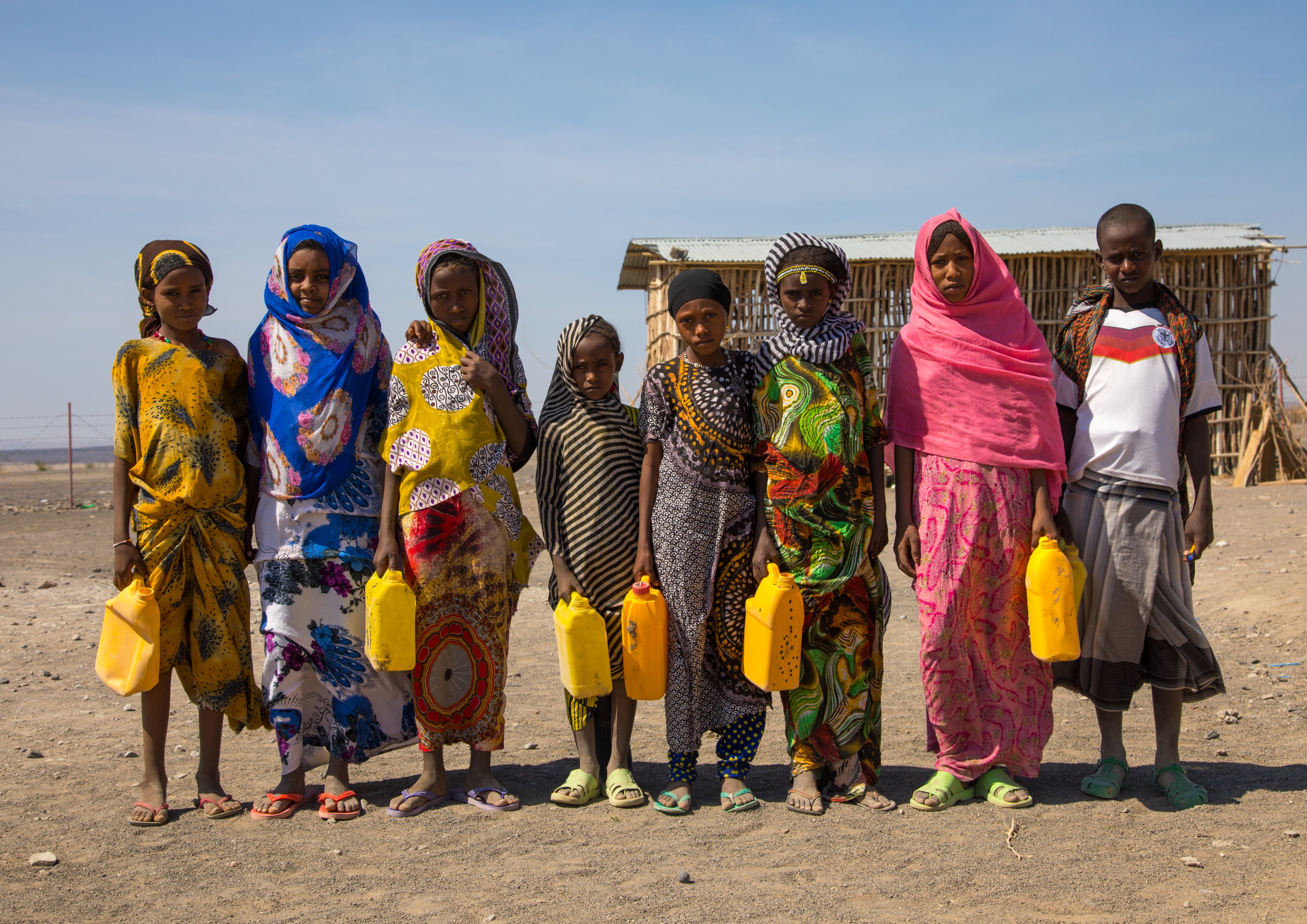 Children collecting water in jericans before going to school, Afar region, Semera, Ethiopia