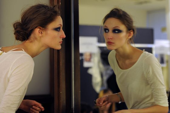 A model looks at her make-up in a mirror prior the Gianfranco Ferre Fall-winter 2012-2013 show on February 27, 2012 during the Women's fashion week in Milan.       AFP PHOTO / GABRIEL BOUYS (Photo credit should read GABRIEL BOUYS/AFP/Getty Images)