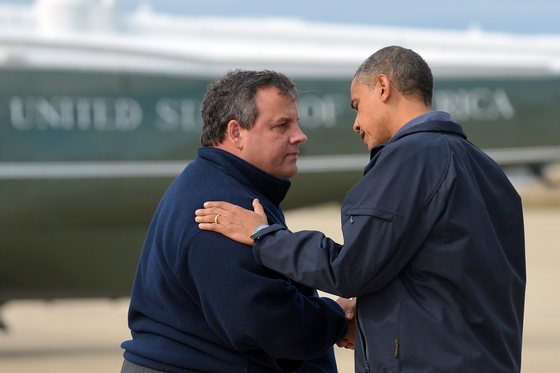 US President Barack Obama (R) is greeted by New Jersey Governor Chris Christie upon arriving in Atlantic City, New Jersey, on October 31, 2012 to visit areas hardest hit by the unprecedented cyclone Sandy. Americans sifted through the wreckage of superstorm Sandy on Wednesday as millions remained without power. The storm carved a trail of devastation across New York City and New Jersey, killing dozens of people in several states, swamping miles of coastline, and throwing the tied-up White House race into disarray just days before the vote. AFP PHOTO/Jewel Samad (Photo credit should read JEWEL SAMAD/AFP/Getty Images)