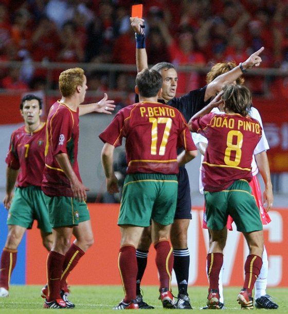 INCHEON, REPUBLIC OF KOREA:  Portugal's Joao Pinto (R#8) receives a red-card from referee Angel Sanchez following a foul on Korea's Park Ji Sung (not pictured) in the 27th minute, 14 June 2002 at the Incheon Munhak Stadium in Incheon, during first round Group D action between Portugal and Korea in the 2002 FIFA World Cup Korea/Japan. AFP PHOTO/EMMANUEL DUNAND (Photo credit should read EMMANUEL DUNAND/AFP/Getty Images)