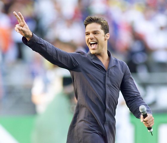 SAINT-DENIS, :  Portorican singer Ricky Martin performs 12 July on the pitch of the Stade de France in Saint-Denis, near Paris, moments before the 1998 Soccer World Cup final match between Brazil and France. (ELECTRONIC IMAGE) AFP PHOTO GABRIEL BOUYS (Photo credit should read GABRIEL BOUYS/AFP/Getty Images)