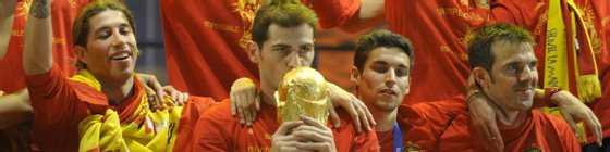 Spain's goalkeeper Iker Casillas kisses the trophy as he celebrates with team mates on a stage set up for the Spanish team victory ceremony in Madrid on July 12, 2010 a day after they won the 2010 FIFA football World Cup match against the Netherlands in Johannesburg.      AFP PHOTO / MIGUEL RIOPA (Photo credit should read MIGUEL RIOPA/AFP/Getty Images)