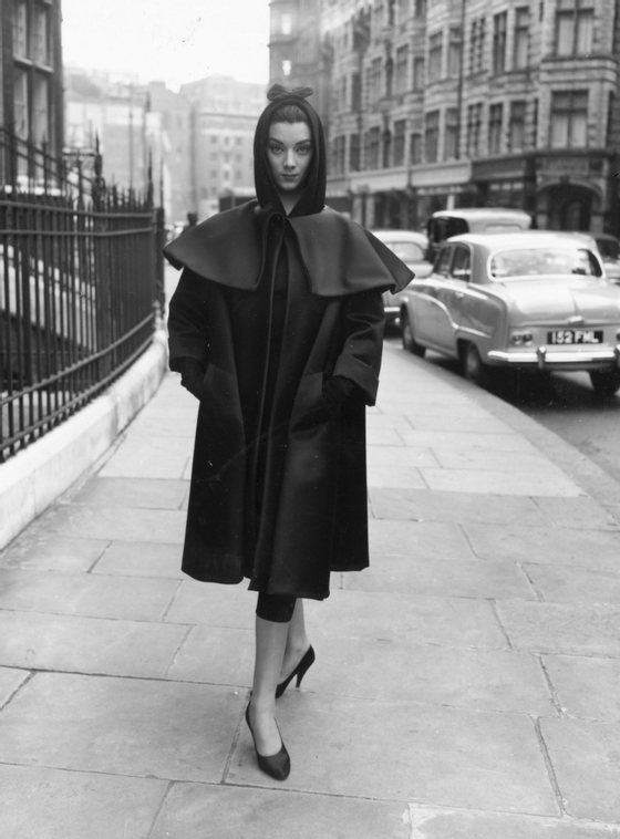 22nd February 1955:  A fashion model wearing a dress and coat by Balenciaga during rehearsals for an appearance on the television show 'Fashions From Paris'.  (Photo by Terry Fincher/Keystone/Getty Images)