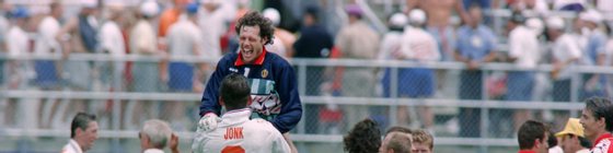 Belgian goalkeeper Michel Preud'homme jumps into the arms of teammate Philippe Albert, wearing Dutch player Wim Jonk's jersey, following Belgium's 1-0 victory over Holland during the World Cup match, on June 25, 1994, at the Citrus Bowl in Orlando.        (Photo credit should read VINCENT AMALVY/AFP/Getty Images)