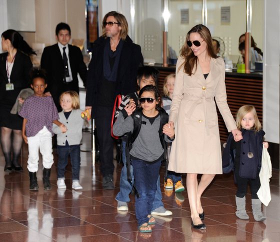 Accompanied by their children, US movie stars Brad Pitt and Angellina Jolie appear before photographers upon their arrival at Haneda Airport in Tokyo on November 8, 2011. Brad Pitt is here for the Japan premiere of his last film 'Moneyball'.   AFP PHOTO/Toru YAMANAKA (Photo credit should read TORU YAMANAKA/AFP/Getty Images)