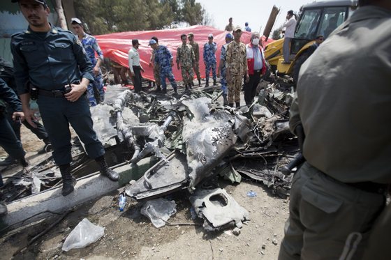 Iranian security forces secure the scene of a plane crash near Tehran's Mehrabad airport on August 10, 2014. An Iranian passenger plane crashed moments after takeoff from Tehran, killing at least 38 people on board and narrowly avoiding many more deaths when it plummeted to earth near a busy market. AFP PHOTO/BEHROUZ MEHRI        (Photo credit should read BEHROUZ MEHRI/AFP/Getty Images)