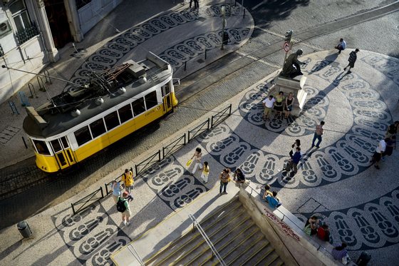TO GO WITH AFP STORY BY LEVI FERNANDES People walk at Chiado, in Lisbon on June 22, 2013. The portuguese pavement is a tourism highlight when they visit Portugal and the graphics evoke the golden age of Portuguese discoveries and the relation with the sea, developed in the nineteenth century.    AFP PHOTO/ PATRICIA DE MELO MOREIRA        (Photo credit should read PATRICIA DE MELO MOREIRA/AFP/Getty Images)