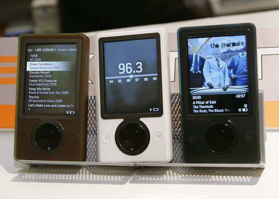 New York, UNITED STATES:  Microsoft's new Zune music player is shown in brown, black and white at RCS Electronics in New York City 14 November 2006. "Zune is either going to take off like a rocket or it is not going to go anyplace," analyst Rob Enderle of Enderle Group in Silicon Valley told AFP "There is no middle ground. It is different enough that it could surprise Apple." Each Zune has a 30-gigabyte media player and is priced at 250 USD, on par with an iPod with an equal amount of memory space. Music for the devices will be sold on the Internet at Zune Marketplace in a manner similar to the exclusive mating of iPod and Apple's online iTunes shop. AFP PHOTO Timothy A. CLARY  (Photo credit should read TIMOTHY A. CLARY/AFP/Getty Images)