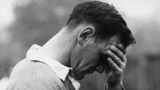 Brian Lochore caprain of the All Blacks, New Zealand rugger team rests his head in his hand after a strenuous training session at Wimbledon before a European tour.   (Photo by Bob Aylott/Getty Images)