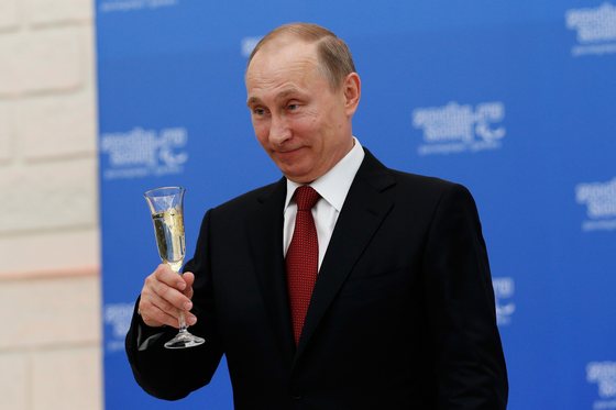 SOCHI, RUSSIA - MARCH 13: Russian President Vladimir Putin holds a glass of champagne during a lunch hosted by the office of the Russian President Vladimir Putin for the Presidents of the International Paralympic Committee member organisations during the 2014 Sochi Paralympic Games on March 13, 2014 in Sochi, Russia.  (Photo by Harry Engels/Getty Images)