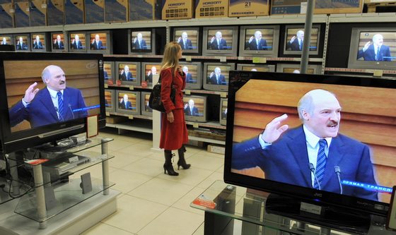 A Belarussian woman watches President Alexander Lukashenko giving his annual address on television at a Minsk electronics store on April 23, 2009. Belarussians should work "day and night" to help the country emerge from the economic crisis, President Alexander Lukashenko said.                   AFP PHOTO / VIKTOR DRACHEV (Photo credit should read VIKTOR DRACHEV/AFP/Getty Images)