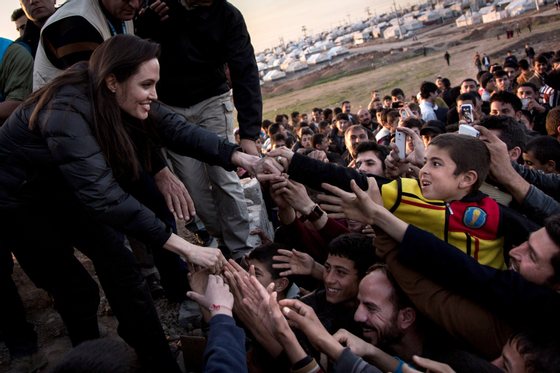 KHANKE, IRAQ - JANUARY 25: In this handout image provided by UNHCR, UNHCR Special Envoy Angelina Jolie meets members of the Yazidi minority in Khanke IDP Camp on January 25, 2015 in Khanke, Iraq. Angelina Jolie was visiting Syrian refugees and displaced Iraqi citizens in the Kurdistan Region of Iraq to offer support to 3.3 million displaced people in the country and highlight their dire needs. (Photo by Andrew McConnell/UNHCR via Getty Images)