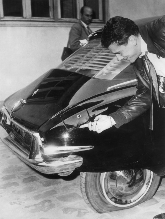 23rd August 1962: A man examines one of the bullet holes in French president General de Gaulle's Citroen DS in Paris, after an assassination attempt in the Paris suburb of Le Petit-Clamart, on 22nd August 1962. (Photo by Keystone/Getty Images)