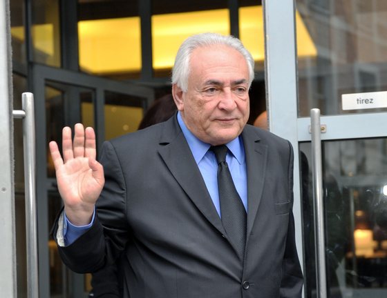 Former IMF chief Dominique Strauss-Kahn leaves his hotel on February 16, 2015, in the northern French city of Lille to attend a session at the third week of the so-called "Lille Carlton Hotel Case" trial. Fourteen people in total are facing the charge, in a trial involving interlocking cases of well-connected friends accused of introducing each other to prostitutes, and procuring prostitutes for sex parties. Strauss-Kahn, the most high-profile protagonist, admited to attending orgies organized by his entourage, but denies knowing the women lavishing their attention on him were prostitutes. AFP PHOTO / FRANCOIS LO PRESTI        (Photo credit should read FRANCOIS LO PRESTI/AFP/Getty Images)