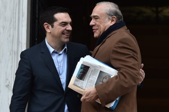 Greek Premier Alexis Tsipras (L) welcomes the head of the Organization for Economic Co-operation and Development (OECD) Angel Gurria before their meeting in Athens on February 11, 2015. Tsipras on announced on Februry 11  plans to work with the OECD to draft a program of reforms to boost growth in the debt-laden country, which is hoping to renegotiate its bailout commitments. AFP PHOTO / ARIS MESSINIS        (Photo credit should read ARIS MESSINIS/AFP/Getty Images)