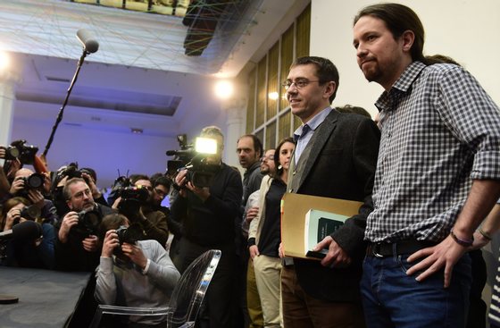 Spanish leader of Podemos Pablo Iglesias (R) and Spanish Secretary of Constituent Process and Programme of Podemos, Juan Carlos Monedero (2nd R), pose for photographers prior to giving a press conference in Madrid on February 20, 2015. Political science professor and founder of Podemos, Juan Carlos Monedero, finds himself embroiled in allegations of tax irregularities that forced him to publish his bank statements in an effort to silence critics.  AFP PHOTO / JAVIER SORIANO        (Photo credit should read JAVIER SORIANO/AFP/Getty Images)