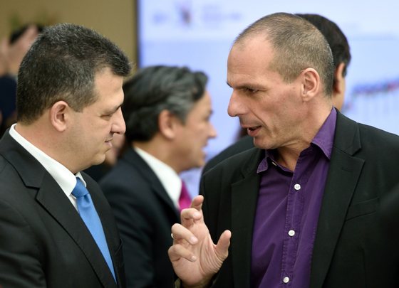 Greek Finance minister Yanis Varoufakis (R) confers prior to leaving the OECD headquarters after the visit of Greece's Prime Minister in Paris, on March 12, 2015. Greece announced on March 12 that it has officially launched a partnership deal with the OECD to draw up economic reforms, which Prime Minister Alexis Tsipras said would help rebuild trust with international creditors. AFP PHOTO / ERIC FEFERBERG .        (Photo credit should read ERIC FEFERBERG/AFP/Getty Images)
