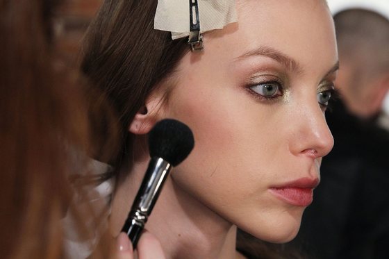 NEW YORK, NY - FEBRUARY 12:  A model gets makeup applied backstage at the Sass & Bide fashion show during Mercedes-Benz Fashion Week Fall 2014 at The Waterfront on February 12, 2014 in New York City.  (Photo by Mireya Acierto/Getty Images)