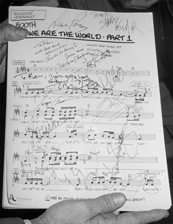 Viwe of the autographed first page of the sheet music for the song 'We Are the World,' written by Michael Jackson and Lionel Richie, 1985. The song was designed to raise awareness and funds for a worldwide hunger relief program, and its international success led the way for the Live Aid concerts later that year. (Photo by Hulton Archive/Getty Images)