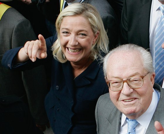 PARIS, FRANCE - MAY 01:  France's far-right National Front President,  Marine Le Pen (L) and her father Jean-Marie Le Pen take part in a march as part of the party's annual celebration of Joan of Arc on May 1, 2011 in Paris, France. France's far-right National Front members took part in its traditional Joan of arc May Day Rally with the party's new leader, as thousands across the globe took to the streets to rally for worker's rights on International Workers' Day.  (Photo by Franck Prevel/Getty Images)